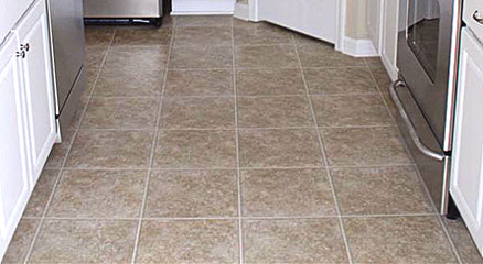 Linoleum flooring in a kitchen with white cabinets